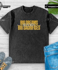 Alt Text: Good Big Dreams Big Sacrifices Requires washed t-shirt displayed on a wooden table with motivational quotes.