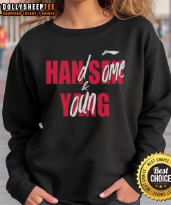 Handsome young man wearing a Good Casey Holdahl sweatshirt, showcasing a stylish casual look.