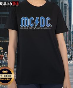 Alt Text: Good Detroit Lions Football Motor City Dan Campbell Ladies Tee featuring team colors and logo design.