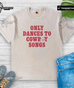 Good George Birge wearing a washed t-shirt, dancing joyfully to cowboy songs at a lively outdoor event.