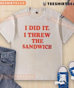 Child proudly shows off a washed T-shirt after throwing a sandwich, capturing the moment of fun and mischief.