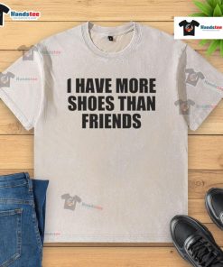 Funny 'Good I Have More Shoes Than Friends' washed t-shirt displayed on a hanger in a stylish closet.