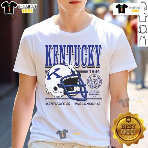 1984 Kentucky Wildcats helmet graphic on a T-shirt celebrating Kentucky 20 Wisconsin 19 football game victory.