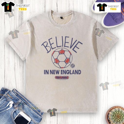 Good New England Revolution Homage MLS x Ted Lasso Believe washed t-shirt featuring iconic design and vibrant colors.