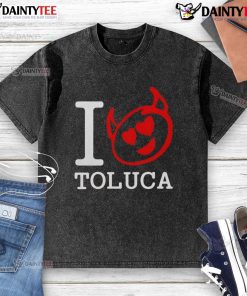 Good Red Devils I Love Toluca washed t-shirt displayed on a hanger, showcasing vibrant colors and casual style.