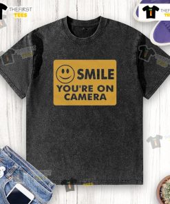 Good Ross Creations 'Smile Youre On Camera' washed t-shirt displayed on a wooden surface, perfect for casual wear.