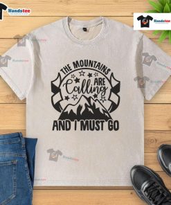 Good The Mountains Are Calling And I Must Go washed t-shirt design with scenic mountain graphics, perfect for outdoor lovers.