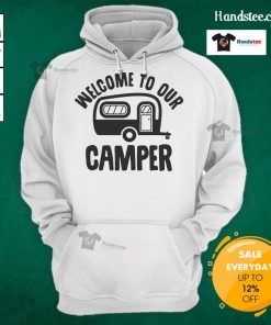Cozy Good Welcome To Our Camper hoodie displayed on a rustic wooden backdrop, perfect for outdoor enthusiasts.