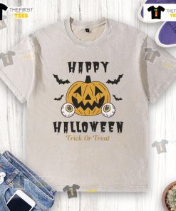 Happy Halloween Trick or Treat pumpkin eyes design on a washed t-shirt, perfect for festive celebrations and spooky fun.