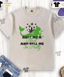 Happy Roll Me A Blunt And Tell Me I'm Pretty washed t-shirt displayed on a hanger, featuring a trendy graphic design.