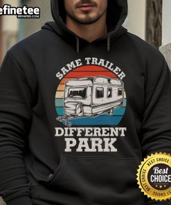 Happy RV camper wearing a vintage hoodie, showcasing the 'Same Trailer, Different Park' theme in a scenic outdoor setting.