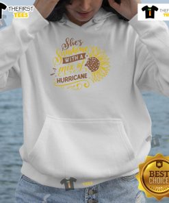 Happy woman wearing a 'Sunshine with a Mix of Hurricane' sunflower hoodie, radiating joy in a vibrant outdoor setting.