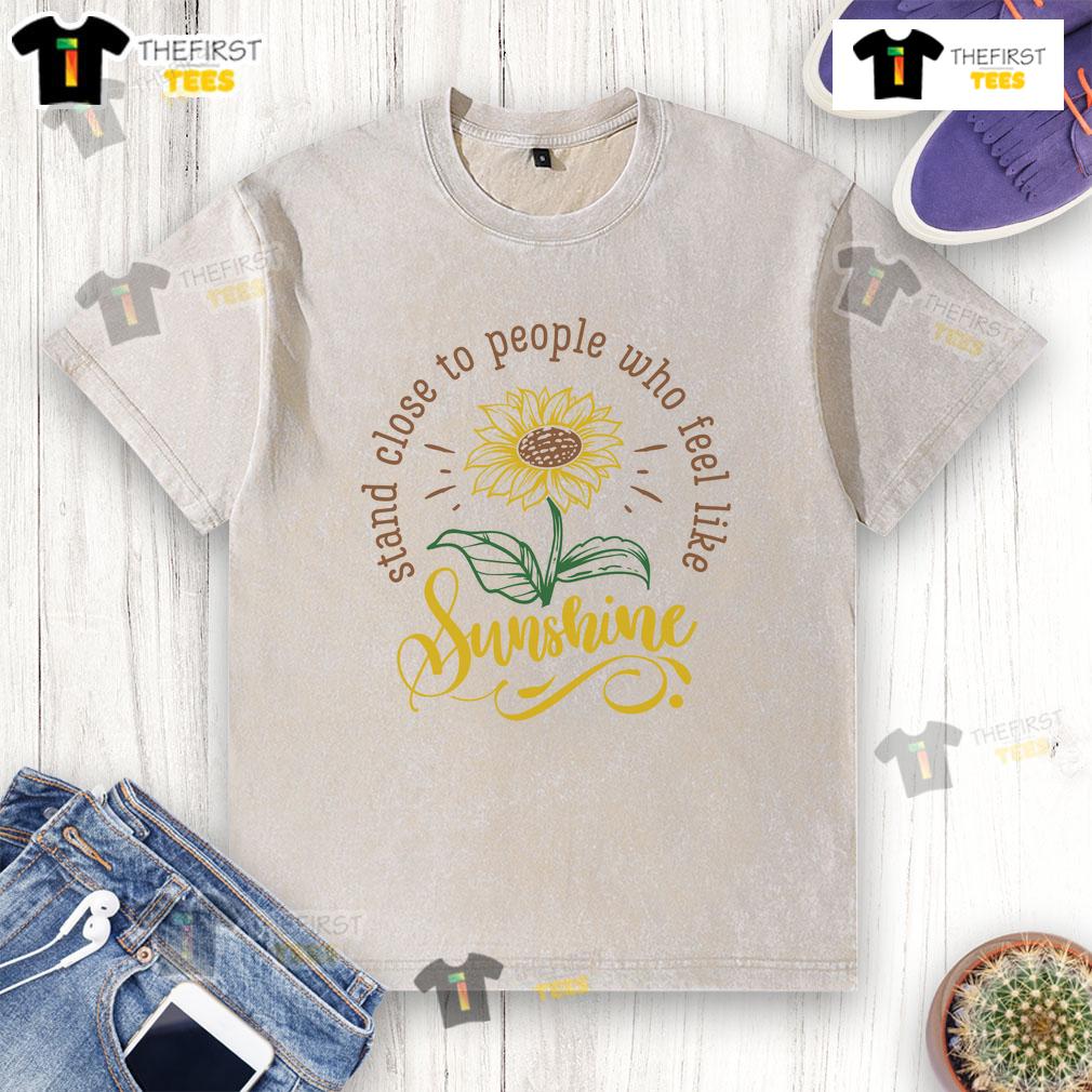 Happy Stand Close To People Who Feel Like Sunshine Washed T Shirt Happy person wearing a 'Feel Like Sunshine' washed t-shirt, standing joyfully close to friends in a sunny park.