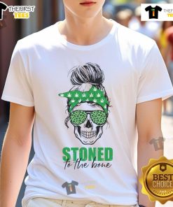 Alt Text: Happy stoned to the bone skull graphic on a weed-themed t-shirt with a messy bun, perfect for cannabis lovers.