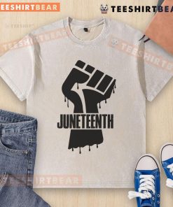 Black fist graphic on a washed T-shirt celebrating Juneteenth, symbolizing freedom and empowerment.