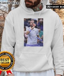 Daniil Medvedev enjoying ice cream on the field at the US Open, wearing a stylish hoodie, capturing a light-hearted moment.