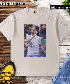 Daniil Medvedev enjoying ice cream on the field at the US Open, wearing a washed t-shirt and smiling.