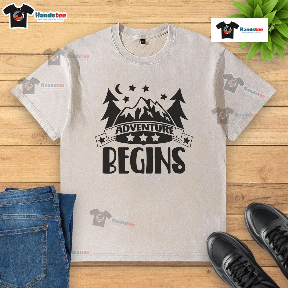 Nice Adventure Begins Washed T Shirt Nice Adventure Begins washed t-shirt displayed on a rustic wooden background, showcasing its soft fabric and relaxed fit.