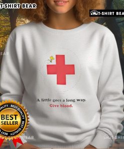 American Red Cross Woodstock sweatshirt promoting blood donation with the slogan 'A Little Goes a Long Way'.