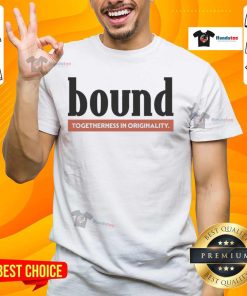 Stylish nice bound red label t-shirt displayed on a wooden surface, showcasing its vibrant color and modern design.
