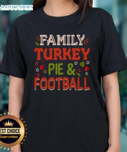 Happy family enjoying turkey pie and football, wearing matching 'Nice Family' ladies tees for a festive gathering.