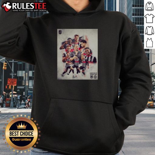 Grimsby Town soccer player wearing a stylish hoodie during a match, showcasing team spirit and athleticism.