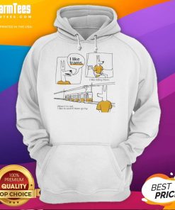 Person wearing a 'Nice I Like Trams I Like Riding Them' hoodie while standing next to a colorful tram in the city.