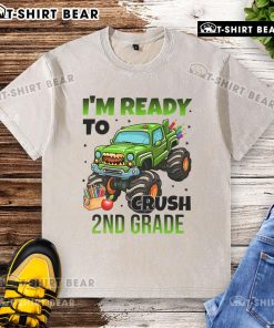 Child wearing a washed t-shirt featuring a monster truck design, ready to crush 2nd grade challenges with confidence.