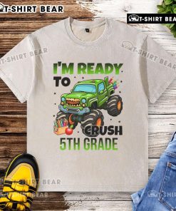 Child wearing a washed t-shirt with a monster truck design, ready to crush 5th grade challenges.