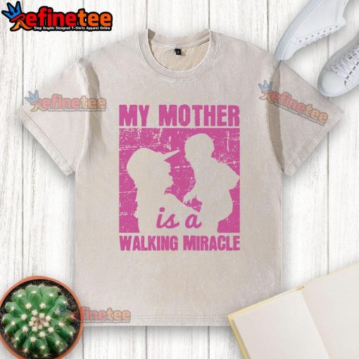 Nice My Mother Is A Walking Miracle washed t-shirt displayed on a hanger, showcasing a heartfelt message for moms.