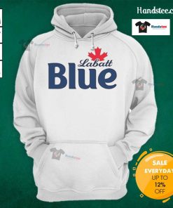 Pamela Anderson wearing a Labatt Blue hoodie, showcasing a stylish and casual look in a vibrant setting.