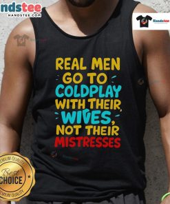 Alt Text: Man wearing 'Nice Real Men Go To Coldplay With Their Wives' tank top, enjoying a concert with his wife.