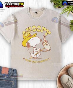 Retro washed t-shirt featuring Snoopy riding a cowboy, perfect for casual wear and fans of Peanuts.