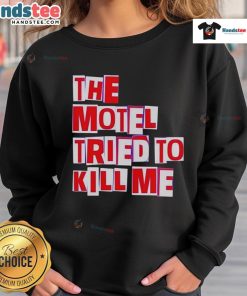 Cozy 'Nice-The-Motel-Tried-To-Kill-Me' sweatshirt displayed on a wooden background, perfect for casual wear.