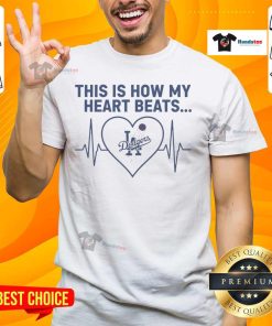 Alt Text: Stylish Los Angeles Dodgers T-shirt featuring 'Nice This Is How My Heart Beats' graphic design for fans.