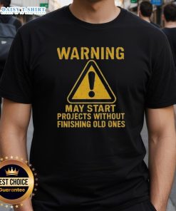 Funny 'Nice Warning May Start Projects Without Finishing Old Ones' T-Shirt design for creative individuals and procrastinators.