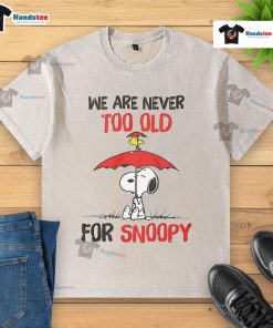 Nice We Are Never Too Old For Snoopy Washed T-Shirt featuring a playful Snoopy graphic on a cozy, vintage-style tee.
