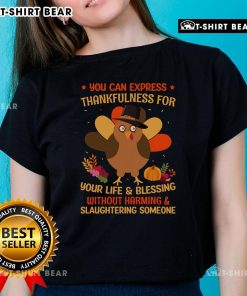 Turquoise ladies' tee with 'Thankfulness Without Harming' graphic, promoting a compassionate Thanksgiving message.