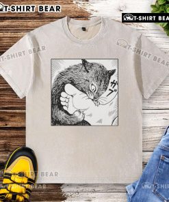Official Cat Bites Feet cartoon design on a washed t-shirt showcasing a playful feline illustration.
