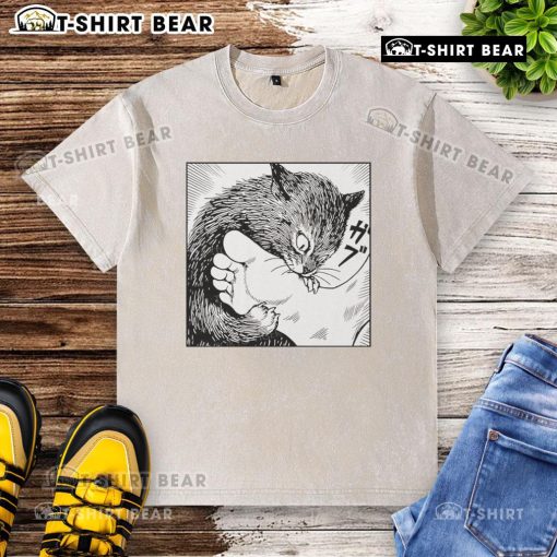 Official Cat Bites Feet cartoon design on a washed t-shirt showcasing a playful feline illustration.