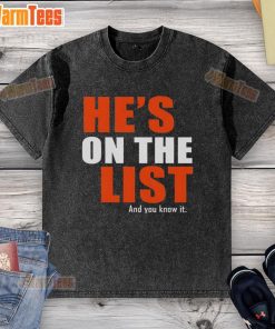 Official 'He's On The List And You Know It' washed t-shirt displayed on a wooden background, perfect for casual wear.