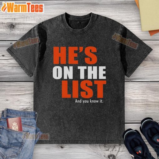 Official 'He's On The List And You Know It' washed t-shirt displayed on a wooden background, perfect for casual wear.