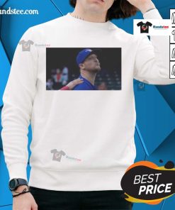 Jeff Hoffman blowing a kiss while wearing a Toronto Blue Jays baseball sweatshirt, showcasing team spirit and style.