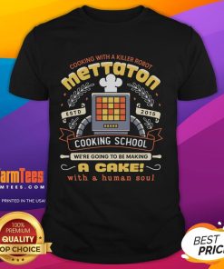 Alt Text: Official Mettaton Cooking School T-Shirt featuring a cake design with a human soul crest, perfect for fans.