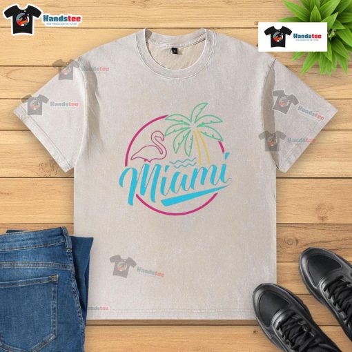 Alt Text: Official Miami Neon Flamingo Logo on a Washed T-Shirt, showcasing vibrant colors and a relaxed, stylish design.