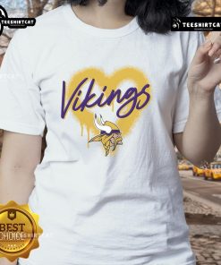Official Minnesota Vikings Football Spray Heart Ladies Tee, stylish women's shirt featuring Vikings colors and logo.