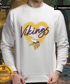 Alt Text: Official Minnesota Vikings Football Spray Heart Sweatshirt featuring a stylish design in team colors for fans.