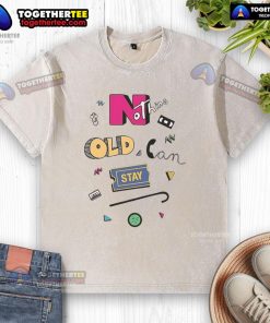 Official Nothing Old Can Stay Washed T-Shirt displayed on a wooden background, showcasing its unique design and fabric.
