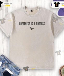 Official Paper Plane Greatness Is A Process washed t-shirt displayed on a hanger, featuring a stylish design and soft fabric.