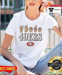 Alt Text: Youth love sign hand signals on an Official San Francisco 49ers football ladies tee, perfect for fans and supporters.